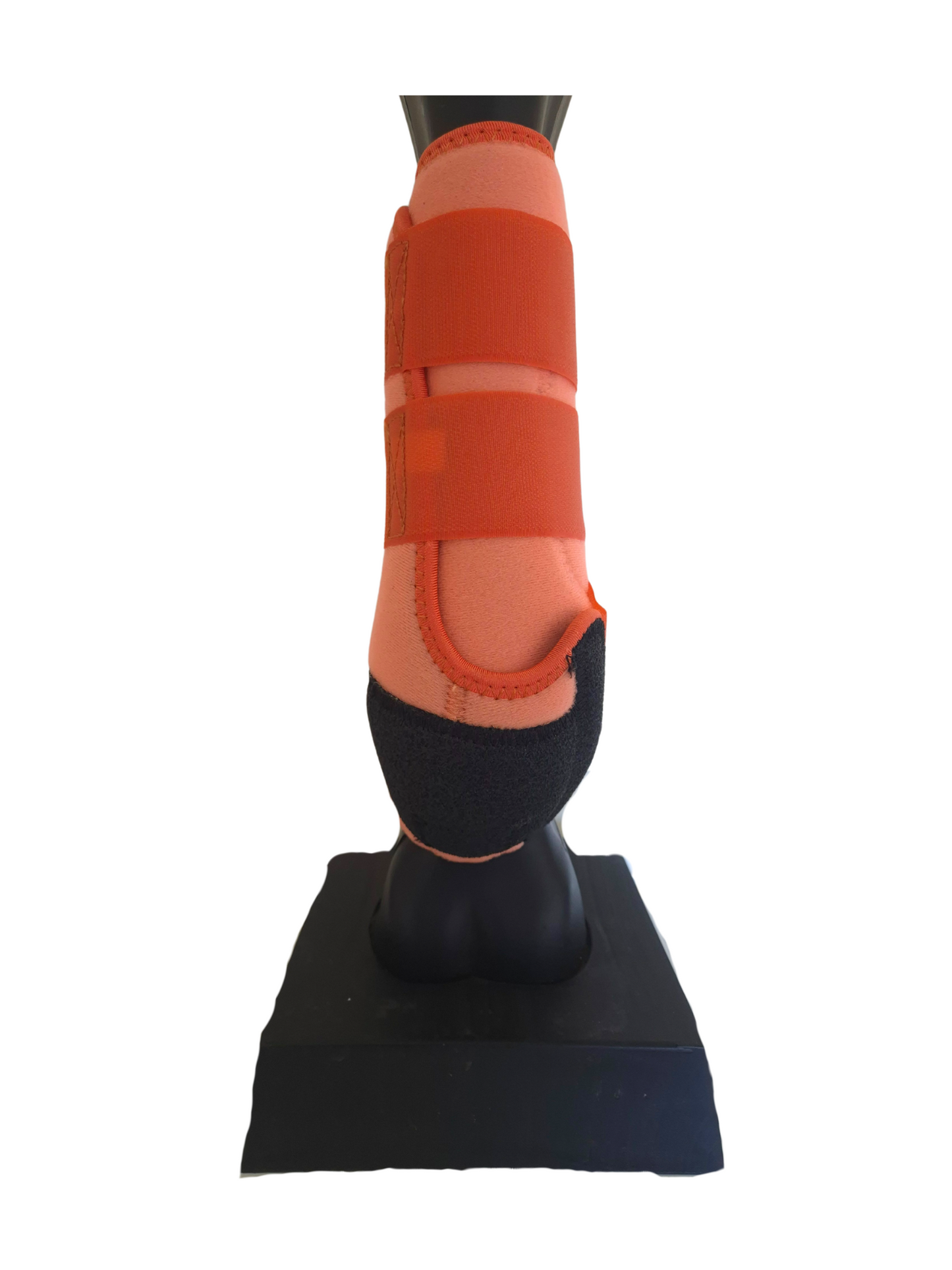 Orange protective boot on a black stand against a white background
