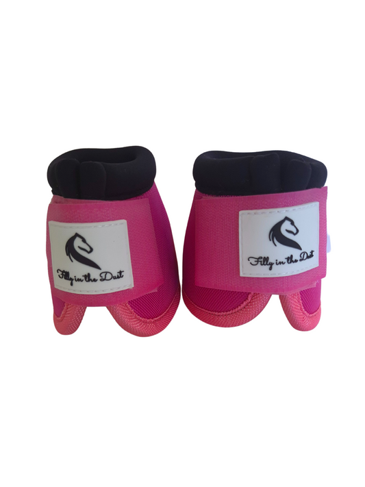 Pair of pink protective horse bell boots with on white background